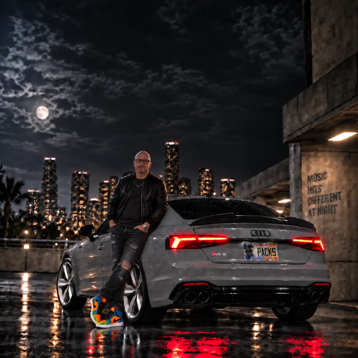 Going the Distance cover art featuring Bill Bass beside a gray Audi RS 5 on a rain-lit city rooftop at night